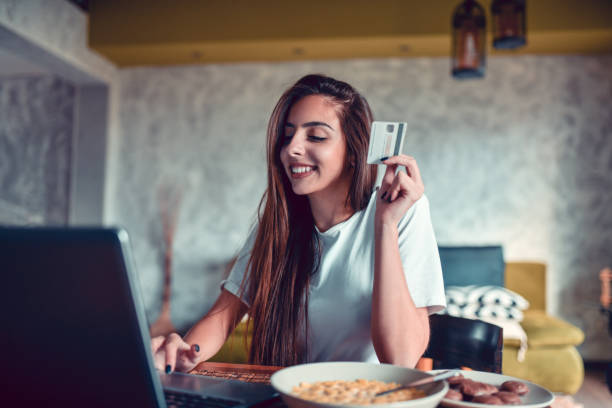 istock Smiling Female Online Shopping During Breakfast Time 1301040452