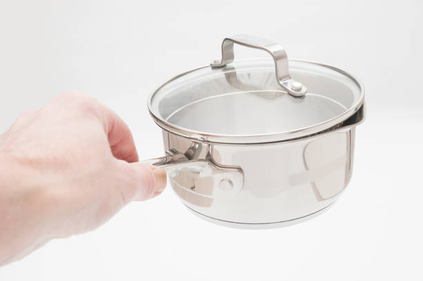 istock Stainless saucepan in hand on white background 1301040491