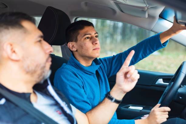 istock Teenage boy having driving lesson with male instructor 1301040538