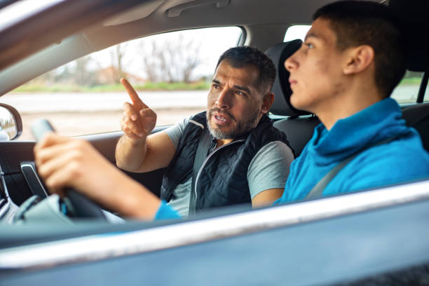 istock Teenage boy having driving lesson with male instructor 1301040579