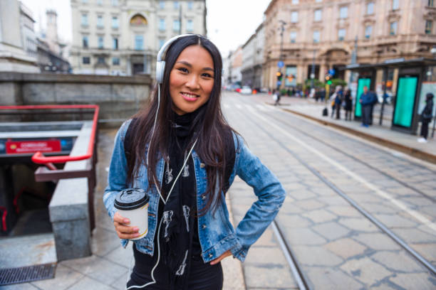 istock Young woman enjoy coffee while walk the streets 1301041785