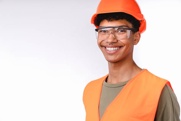 istock Smiling young construction worker in special uniform and hard hat isolated over white background 1301041828