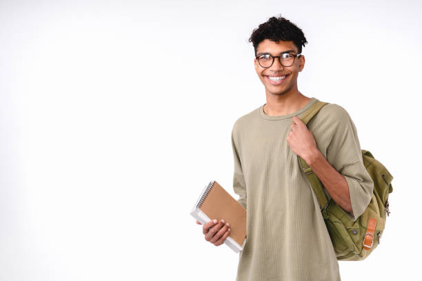 istock Smart young african student with bag and books isolated over white background 1301041842