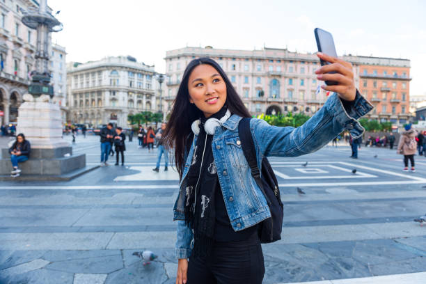 istock Beautiful young woman in a city 1301042157