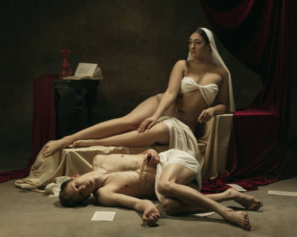 istock Modern remake of classical artwork - young medieval couple on dark background, comparison of eras concept 1301042290