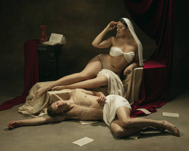 istock Modern remake of classical artwork - young medieval couple on dark background, comparison of eras concept 1301042298