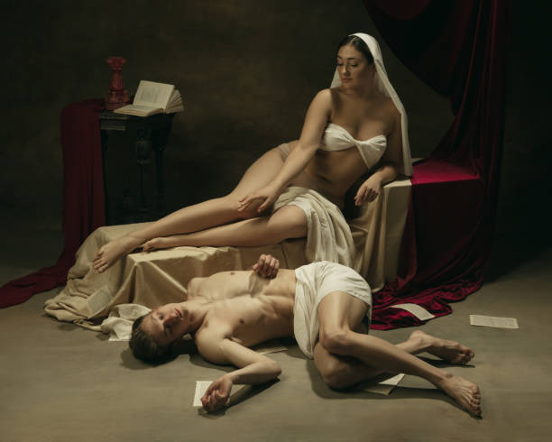 istock Modern remake of classical artwork - young medieval couple on dark background, comparison of eras concept 1301042300