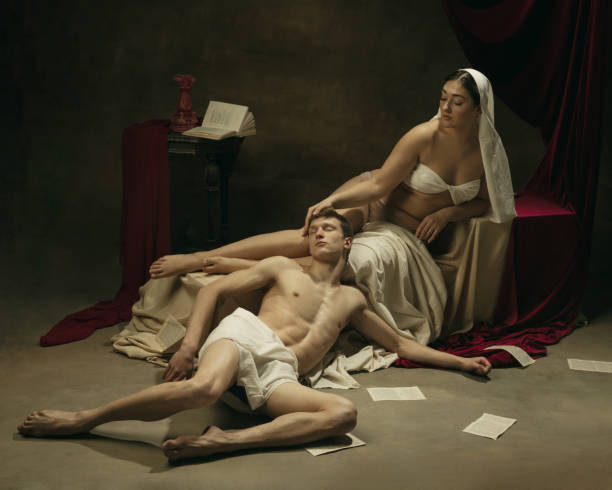 istock Modern remake of classical artwork - young medieval couple on dark background, comparison of eras concept 1301042345