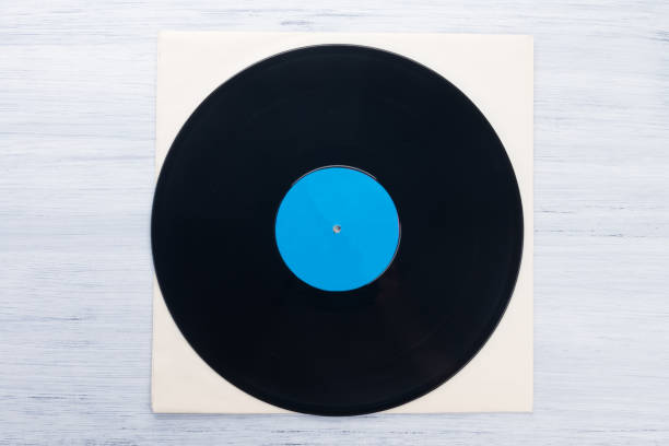 istock on a light gray background, on a paper envelope, lies a vinyl record, close-up 1301042346