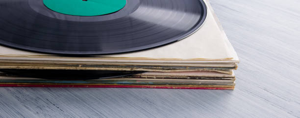 istock a stack of vinyl records in paper cases, on a gray table, background 1301042351