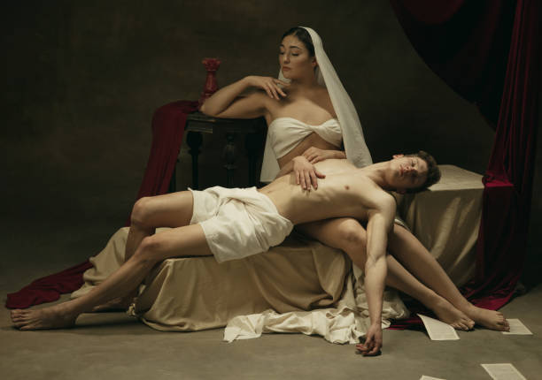 istock Modern remake of classical artwork - young medieval couple on dark background, comparison of eras concept 1301042352