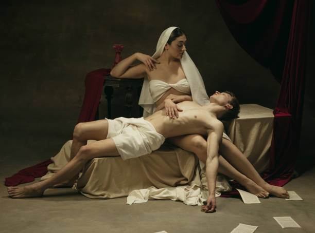 istock Modern remake of classical artwork - young medieval couple on dark background, comparison of eras concept 1301042377