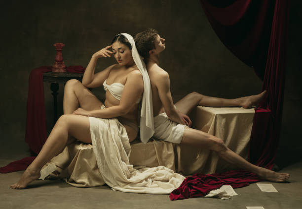 istock Modern remake of classical artwork - young medieval couple on dark background, comparison of eras concept 1301042393