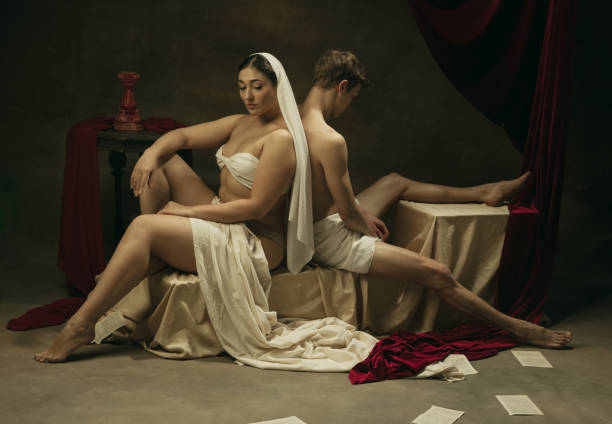 istock Modern remake of classical artwork - young medieval couple on dark background, comparison of eras concept 1301042400