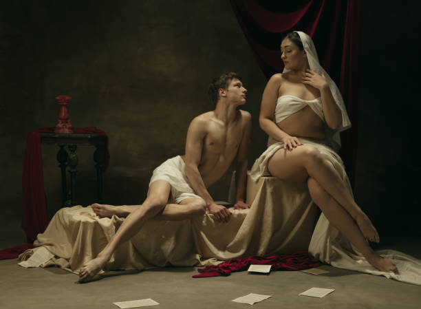istock Modern remake of classical artwork - young medieval couple on dark background, comparison of eras concept 1301042410