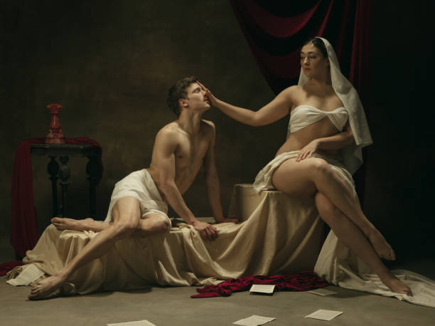 istock Modern remake of classical artwork - young medieval couple on dark background, comparison of eras concept 1301042413