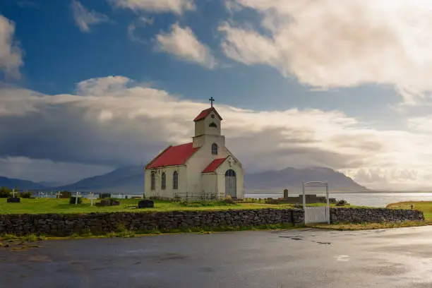 Photo of Innra-Holmskirkja church with a cemetery in Iceland