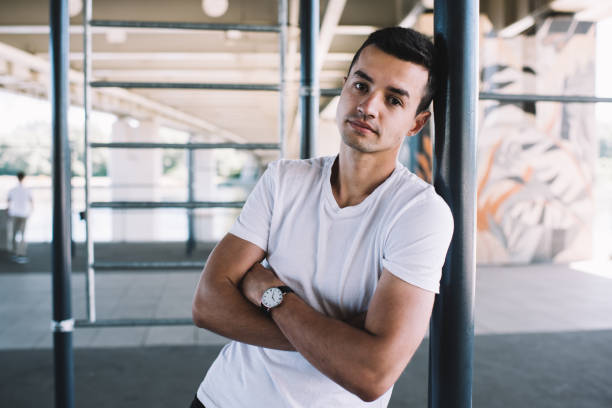 istock Handsome guy leaning on pillar in urban sport area 1301044181