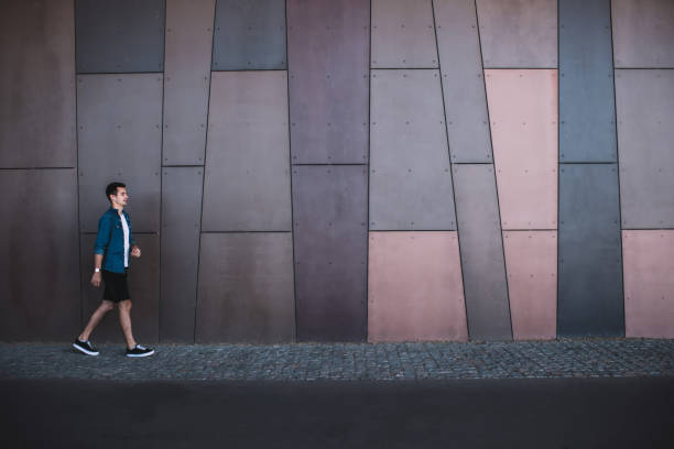 istock Confident guy in casual outfit walking on street 1301044233