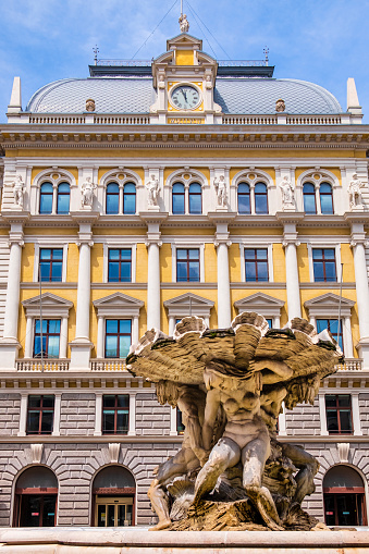 The Tritons fountain, built in 1898 by the sculptor Franz Schranz, stands in the centre of Vittorio Veneto Square. On the back you can see the Palazzo delle Poste, a notable building dating to the late 1800s.