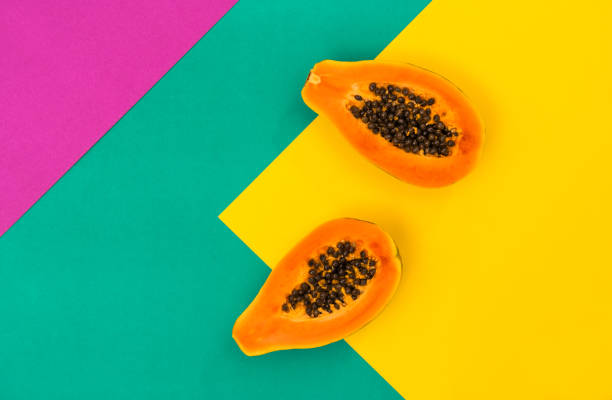 istock Papaya fruit colorful background Creative food flatlay 1301045252