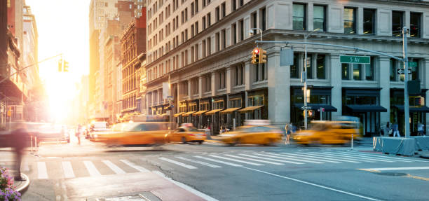 istock New York City - Busy intersection with yellow taxis speeding through the crowded intersection of 5th Avenue and 23rd Street with sunset background 1301045461
