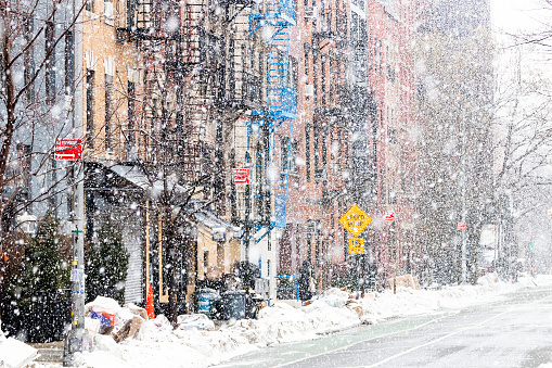 Snowy winter scene with buildings along 12th Street during a snowstorm in the East Village of New York City NYC
