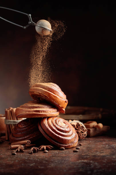 istock Freshly baked sweet buns sprinkled with cinnamon powder. 1301045788