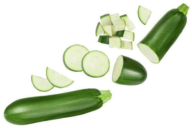 istock Fresh sliced zucchini isolated on white background. Top view with copy space for your text. Flat lay 1301045944