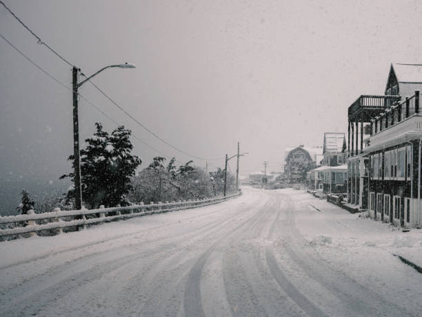 retro style snowscape an der shore road in falmouth, massachusetts - town rural scene road new england stock-fotos und bilder