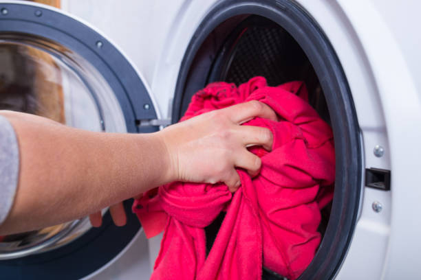 istock Laundry day. derty clothes to washing machine 1301047507