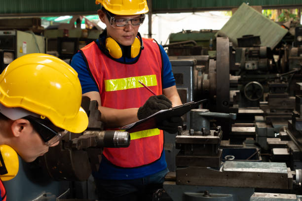 istock Group of skillful factory workers using machine equipment in workshop 1301047651