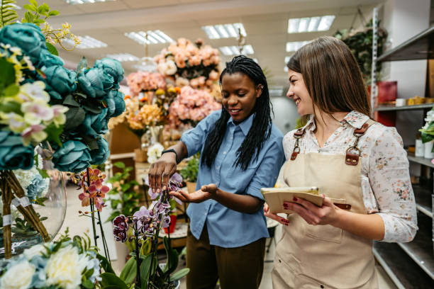 istock Florist showing plants to a female customer 1301049083