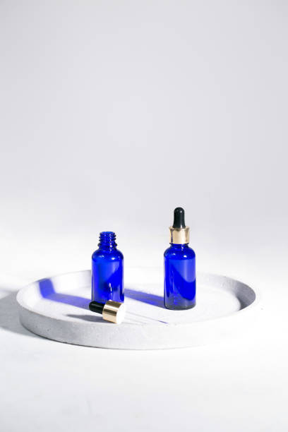 istock Blue dropper bottles on the white background 1301049153