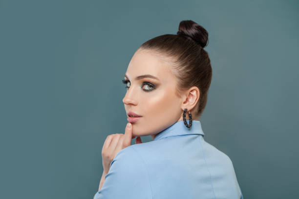 istock Pretty young woman portrait on blue background 1301049272