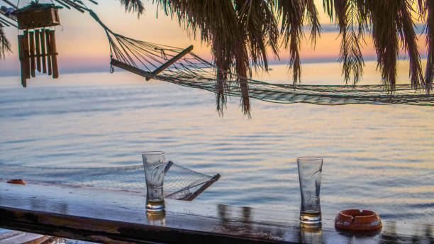 istock Hanging bed under palm trees on tropical beach 1301049311