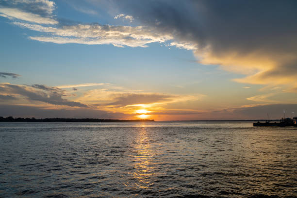 istock Beautiful sunset view on the Amazon River and colorful clouds. Amazonas, Brazil. Concept of environment, ecology, nature, conservation, travel destination, idyllic landscape, climate change. 1301050216