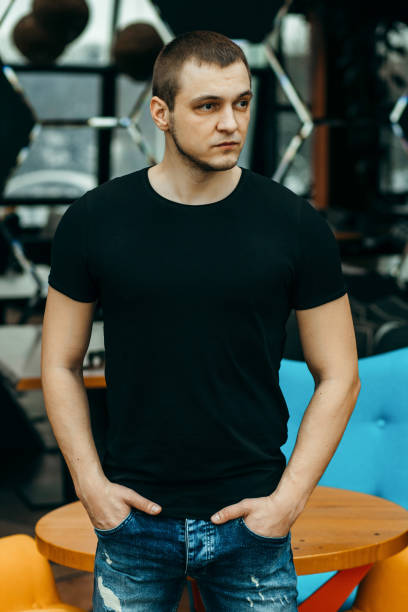 istock Stylish muscular men wearing black t-shirt posing in studio 1301050889