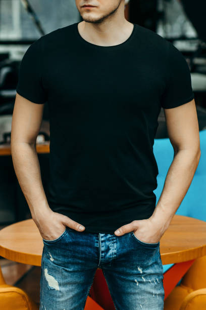 istock Stylish muscular men wearing black t-shirt posing in studio 1301050995