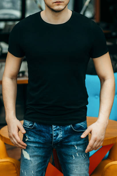 istock Stylish muscular men wearing black t-shirt posing in studio 1301051145