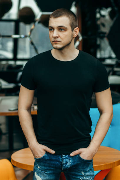 istock Stylish muscular men wearing black t-shirt posing in studio 1301051149