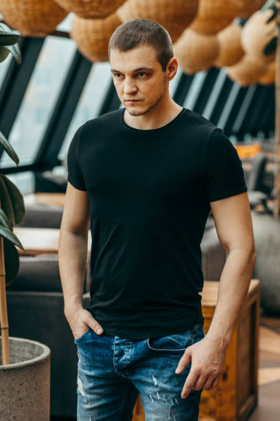 istock Stylish muscular men wearing black t-shirt posing in studio 1301051228