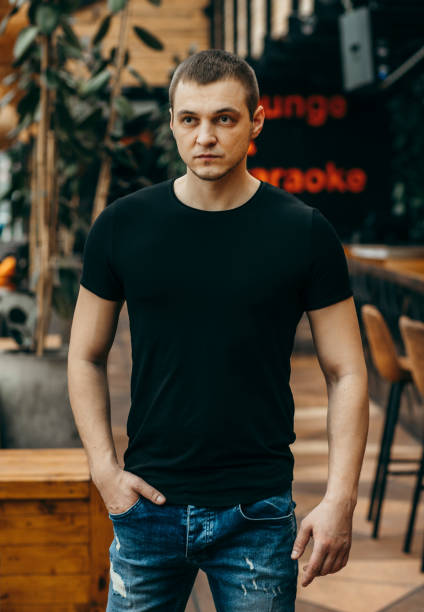 istock Stylish muscular men wearing black t-shirt posing in studio 1301051232