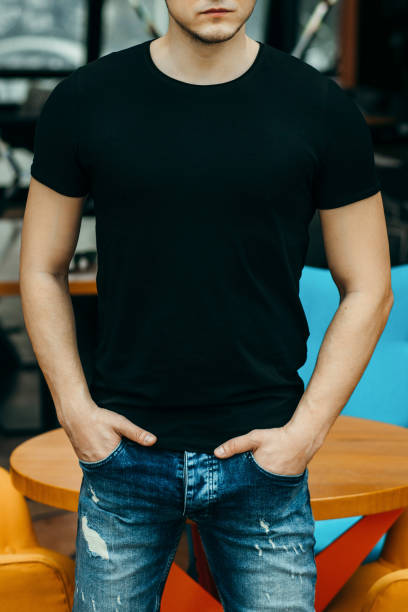 istock Stylish muscular men wearing black t-shirt posing in studio 1301051251