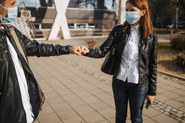 istock Fist bump in front of office building 1301052464