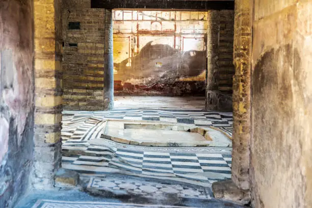 Interior of a house with its marble floor in the roman ruins of the ancient archaeological site of Herculaneum in Ercolano, Italy