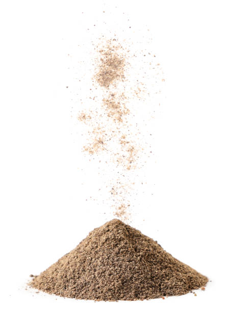istock Black ground pepper is poured on a pile on a white background. Isolated 1301054325
