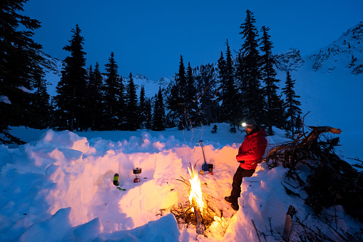 Winter camp on a backcountry ski trip. Staying warm in winter. Adventure in the mountains.