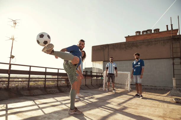 istock People playing football on a building rooftop terrace 1301057069