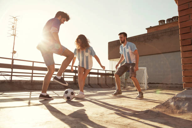 istock People having fun playing football on a building rooftop terrace 1301057091